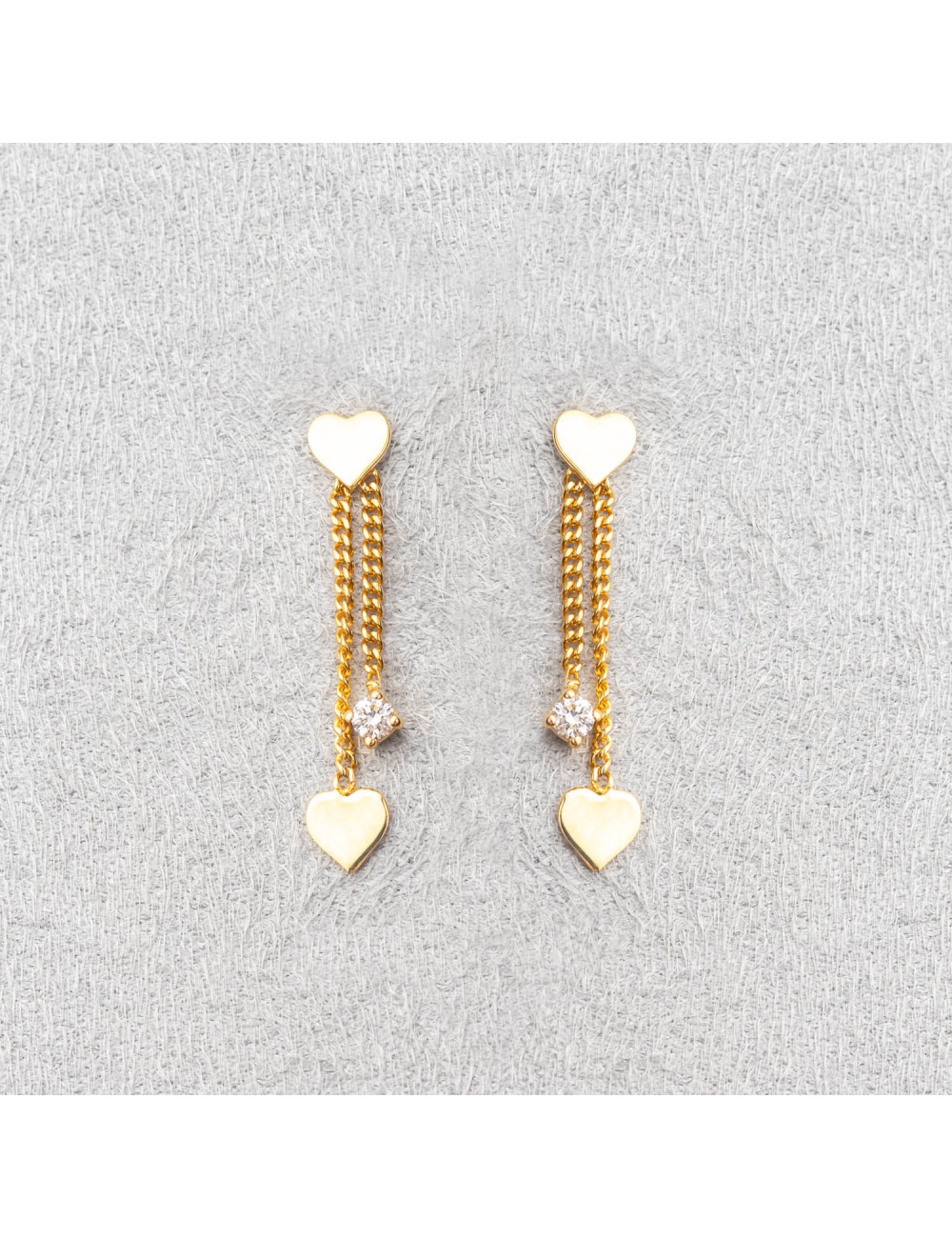 Boucle d'oreille femme double coeur et diamant de laboratoire.